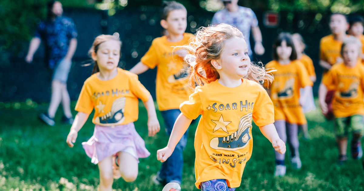 Elementary school students running during a fun run event